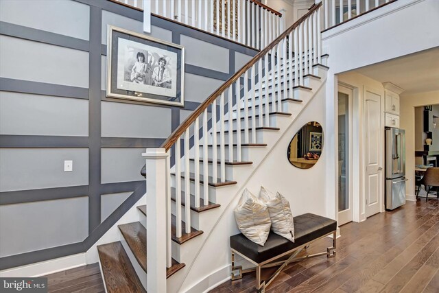 stairway featuring wood finished floors and baseboards