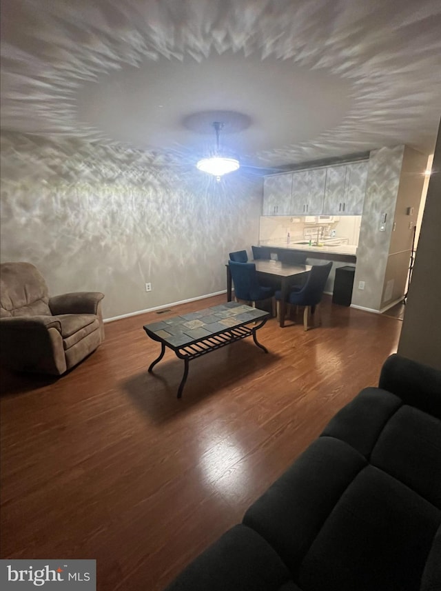 living room with dark wood-style flooring and baseboards