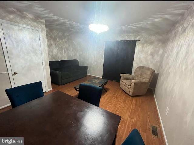 interior space featuring visible vents, wood finished floors, and baseboards