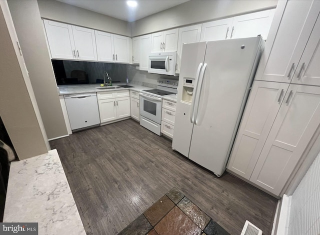kitchen featuring dark wood-style flooring, white appliances, white cabinets, and visible vents