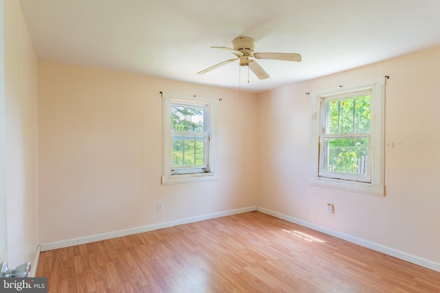 unfurnished room featuring light wood-style floors, ceiling fan, and baseboards