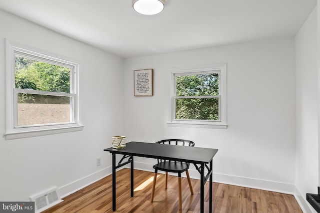 office area featuring plenty of natural light, wood finished floors, and baseboards