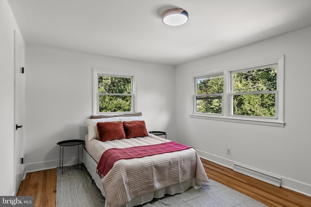 bedroom featuring baseboards and wood finished floors