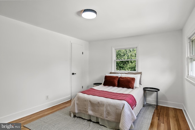 bedroom with wood finished floors and baseboards