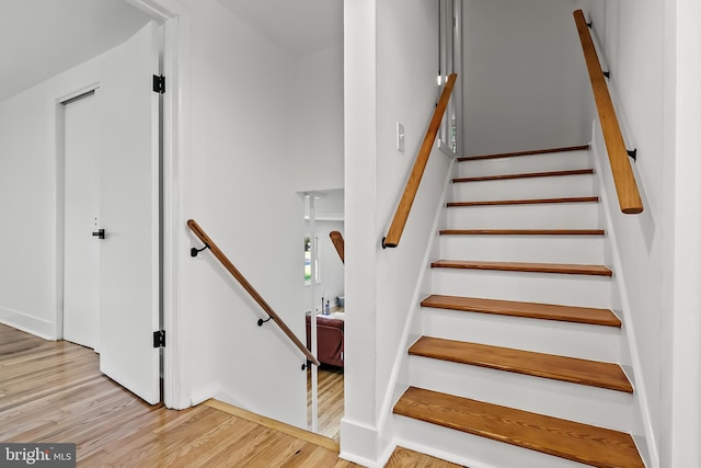 staircase with wood finished floors