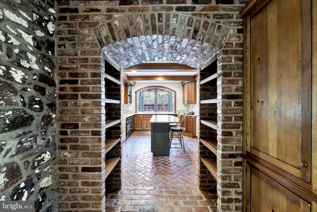 wine area featuring brick floor