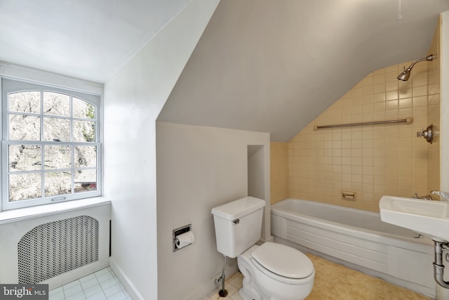 bathroom featuring toilet, a sink, shower / bath combination, tile patterned flooring, and lofted ceiling