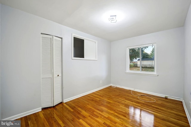 4112 Norcross St, Temple Hills, MD 20748 - unfurnished bedroom featuring baseboards, a closet, and wood finished floors