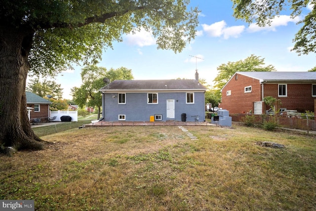 4112 Norcross St, Temple Hills, MD 20748 - back of house with a yard, fence, and a chimney