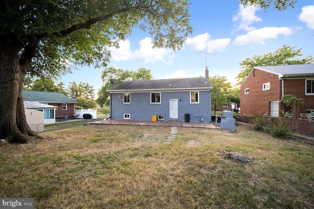4112 Norcross St, Temple Hills, MD 20748 - back of house with fence, a chimney, and a lawn