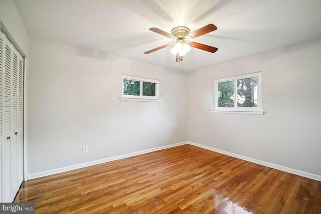 4112 Norcross St, Temple Hills, MD 20748 - unfurnished bedroom featuring baseboards, multiple windows, light wood-style floors, and a closet