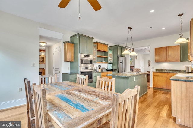 dining area with ceiling fan, baseboards, light wood finished floors, and recessed lighting