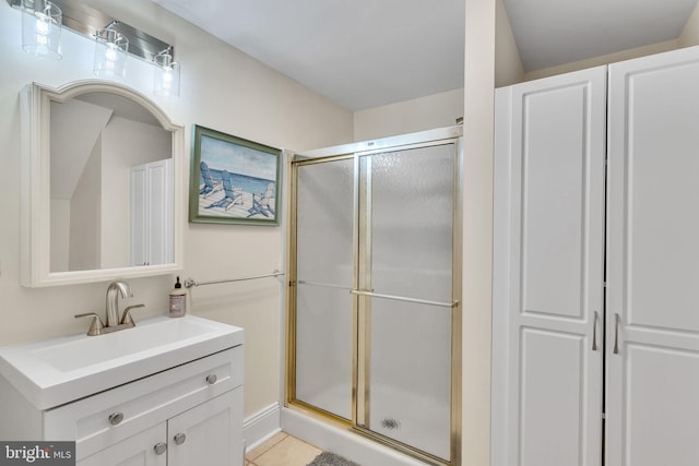 bathroom with vanity, tile patterned flooring, and a stall shower