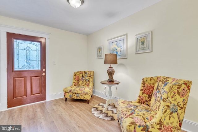living area featuring wood finished floors and baseboards