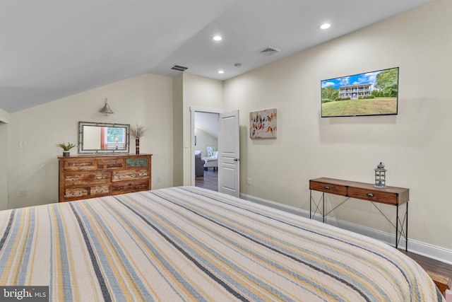 bedroom featuring lofted ceiling, wood finished floors, visible vents, recessed lighting, and baseboards