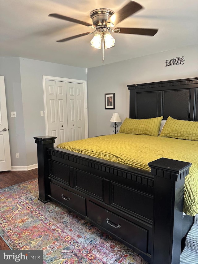 8186 Ebbtide Ln, Lusby, MD 20657 - bedroom with baseboards, dark wood-style flooring, a closet, and a ceiling fan