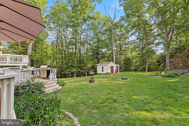 8186 Ebbtide Ln, Lusby, MD 20657 - view of yard with a fire pit, an outbuilding, and a wooden deck