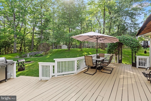 8186 Ebbtide Ln, Lusby, MD 20657 - wooden deck with a yard, outdoor dining area, an outdoor structure, and a storage unit