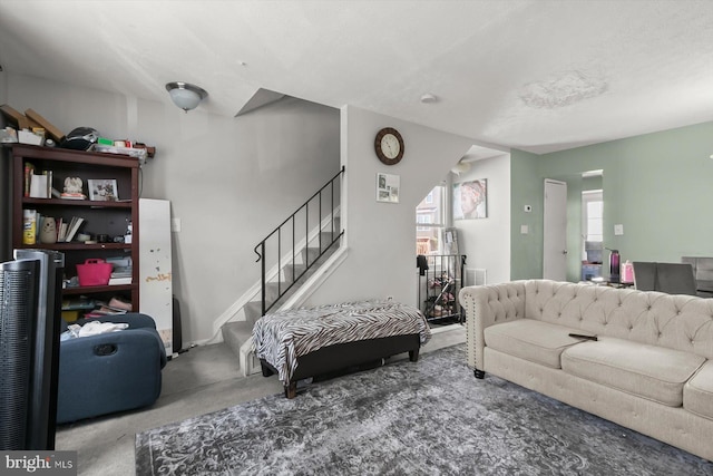 living room featuring carpet flooring and stairway