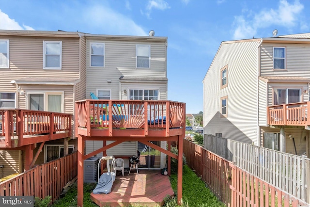 back of property featuring cooling unit, a fenced backyard, and a wooden deck
