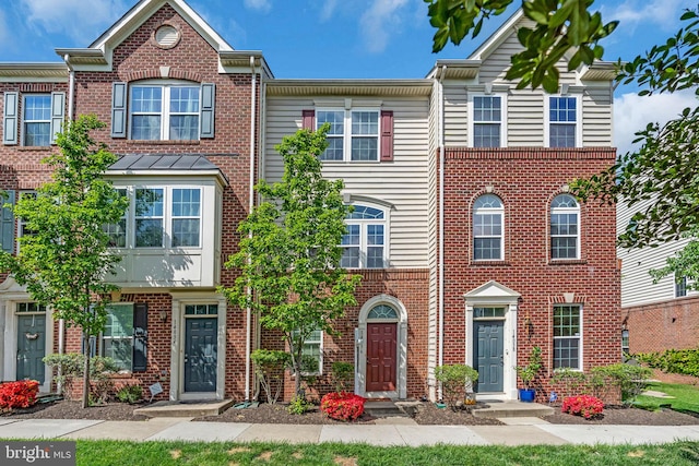 townhome / multi-family property with brick siding