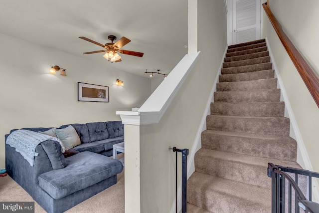 staircase with carpet and ceiling fan