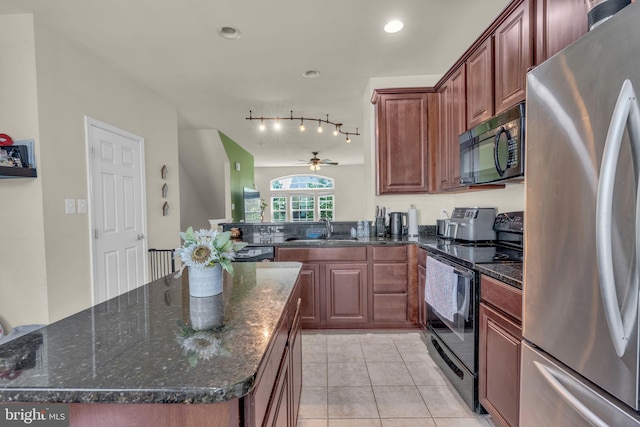 kitchen with a ceiling fan, light tile patterned flooring, a sink, dark stone countertops, and black appliances
