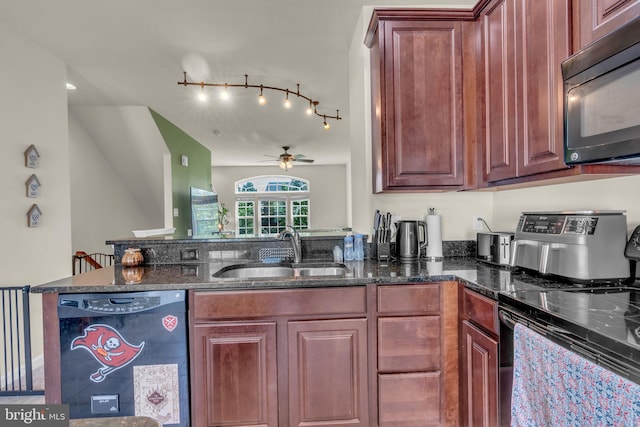 kitchen with ceiling fan, a sink, a peninsula, dark stone countertops, and black appliances