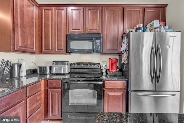 kitchen featuring dark stone counters and black appliances
