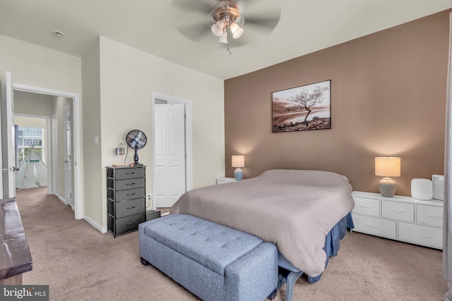 bedroom with light colored carpet and a ceiling fan