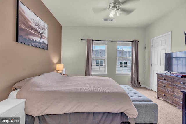 bedroom featuring light carpet, baseboards, a ceiling fan, and visible vents