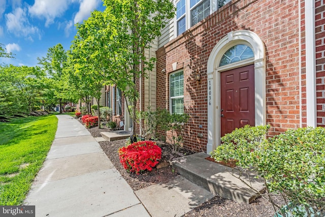 view of exterior entry with brick siding