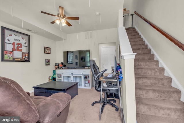 office area featuring carpet flooring, attic access, visible vents, and a ceiling fan