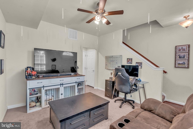 office area featuring attic access, visible vents, light carpet, a ceiling fan, and baseboards