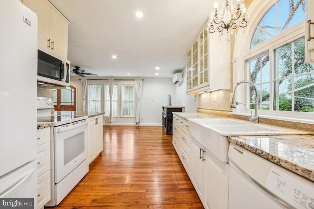 905 Burke Dr, Woodbridge, VA 22191 - kitchen with white appliances, a wall mounted AC, light wood-style floors, recessed lighting, and glass insert cabinets