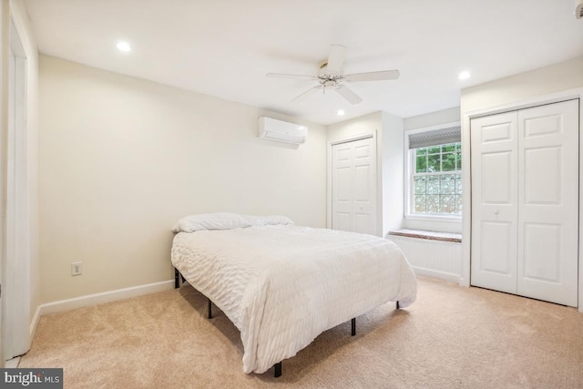 905 Burke Dr, Woodbridge, VA 22191 - bedroom with a wall mounted AC, two closets, light colored carpet, recessed lighting, and baseboards