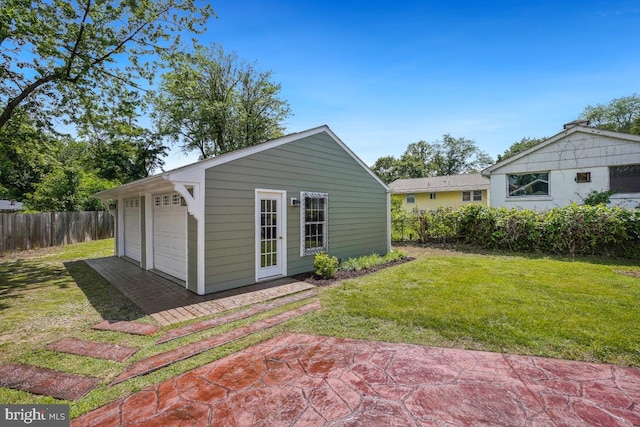 905 Burke Dr, Woodbridge, VA 22191 - rear view of house featuring a garage and an outbuilding