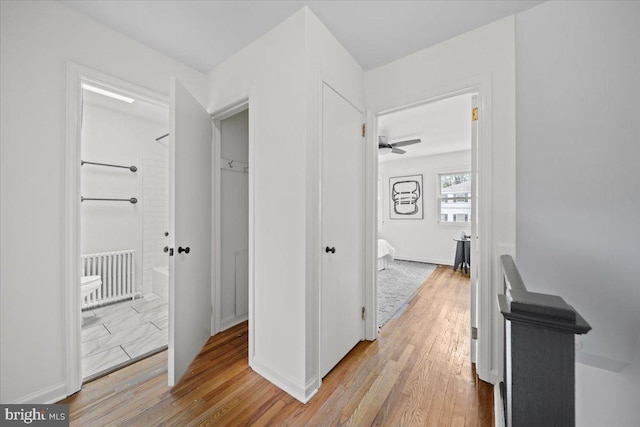 hallway with baseboards and wood finished floors