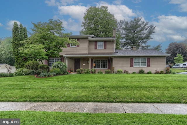 traditional-style house with a chimney and a front yard