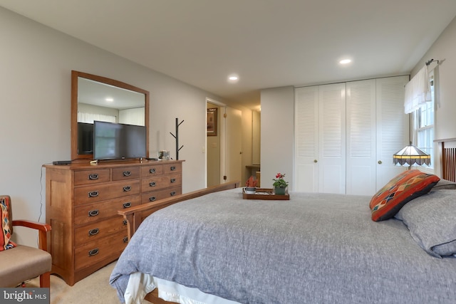 bedroom featuring light carpet, a closet, and recessed lighting