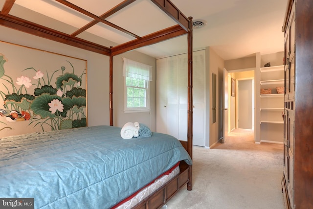 bedroom with light colored carpet and a closet