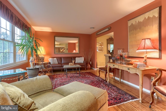 living area with wood finished floors and baseboards
