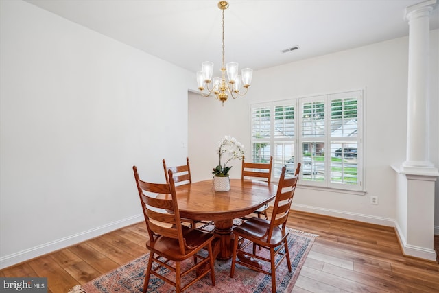 701 Ballast Way, Annapolis, MD 21401 - dining area featuring decorative columns, wood-type flooring, a chandelier, and baseboards