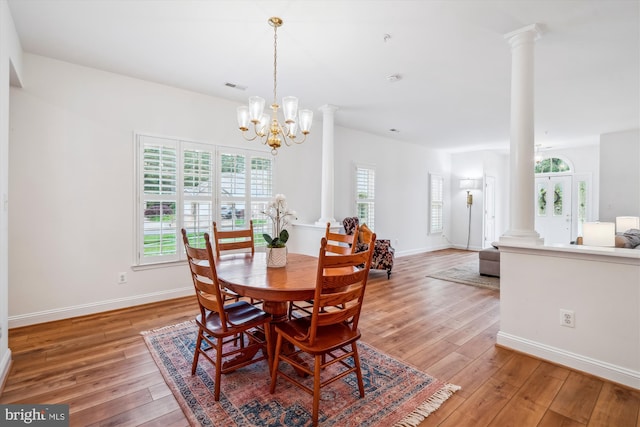 701 Ballast Way, Annapolis, MD 21401 - dining room with decorative columns, light wood finished floors, a chandelier, and baseboards