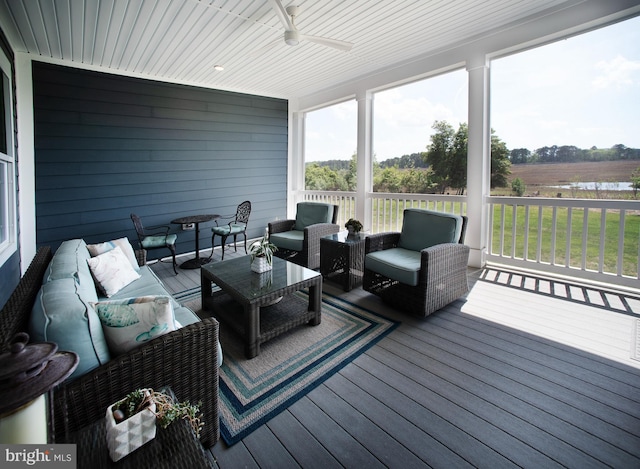 deck with outdoor lounge area and a ceiling fan