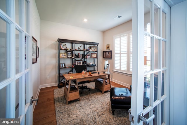 office space with wood finished floors, visible vents, french doors, and baseboards
