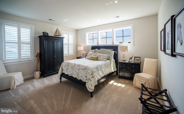 bedroom featuring light colored carpet, visible vents, and baseboards