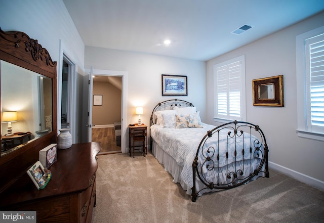 carpeted bedroom featuring baseboards and visible vents