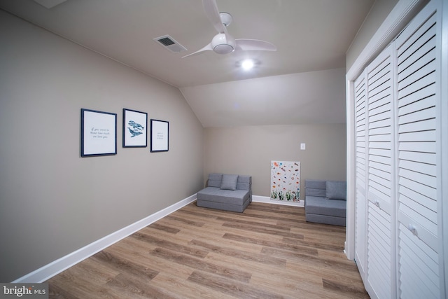 unfurnished room featuring baseboards, light wood finished floors, ceiling fan, visible vents, and vaulted ceiling