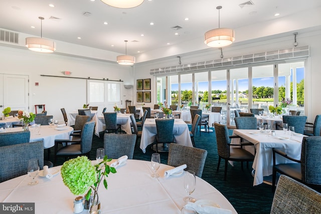 dining area featuring a healthy amount of sunlight, visible vents, and recessed lighting